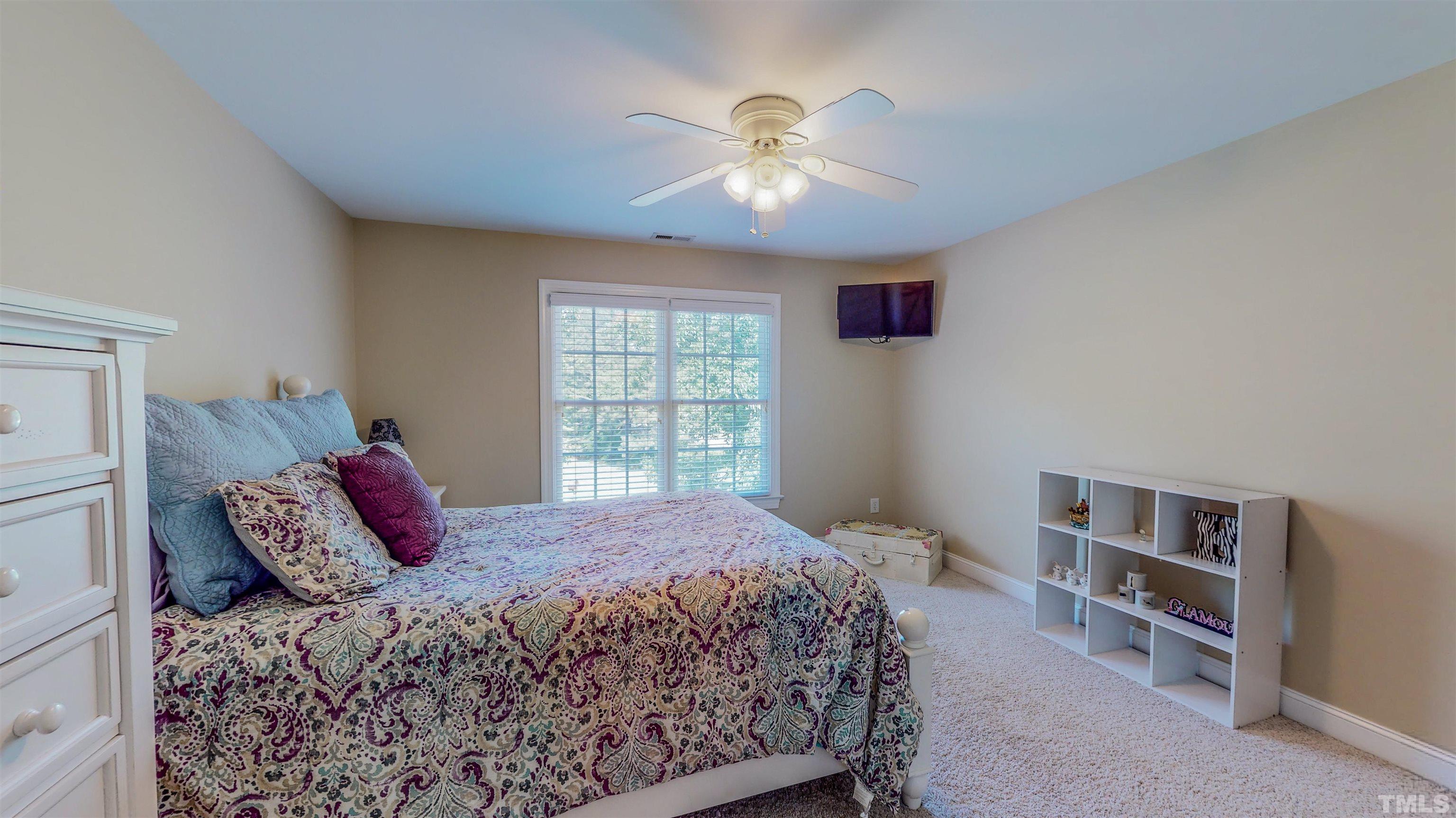 102 Continental Drive Durham, NC 27712 - Photo 42 of 86 a bedroom with a bed and a chandelier