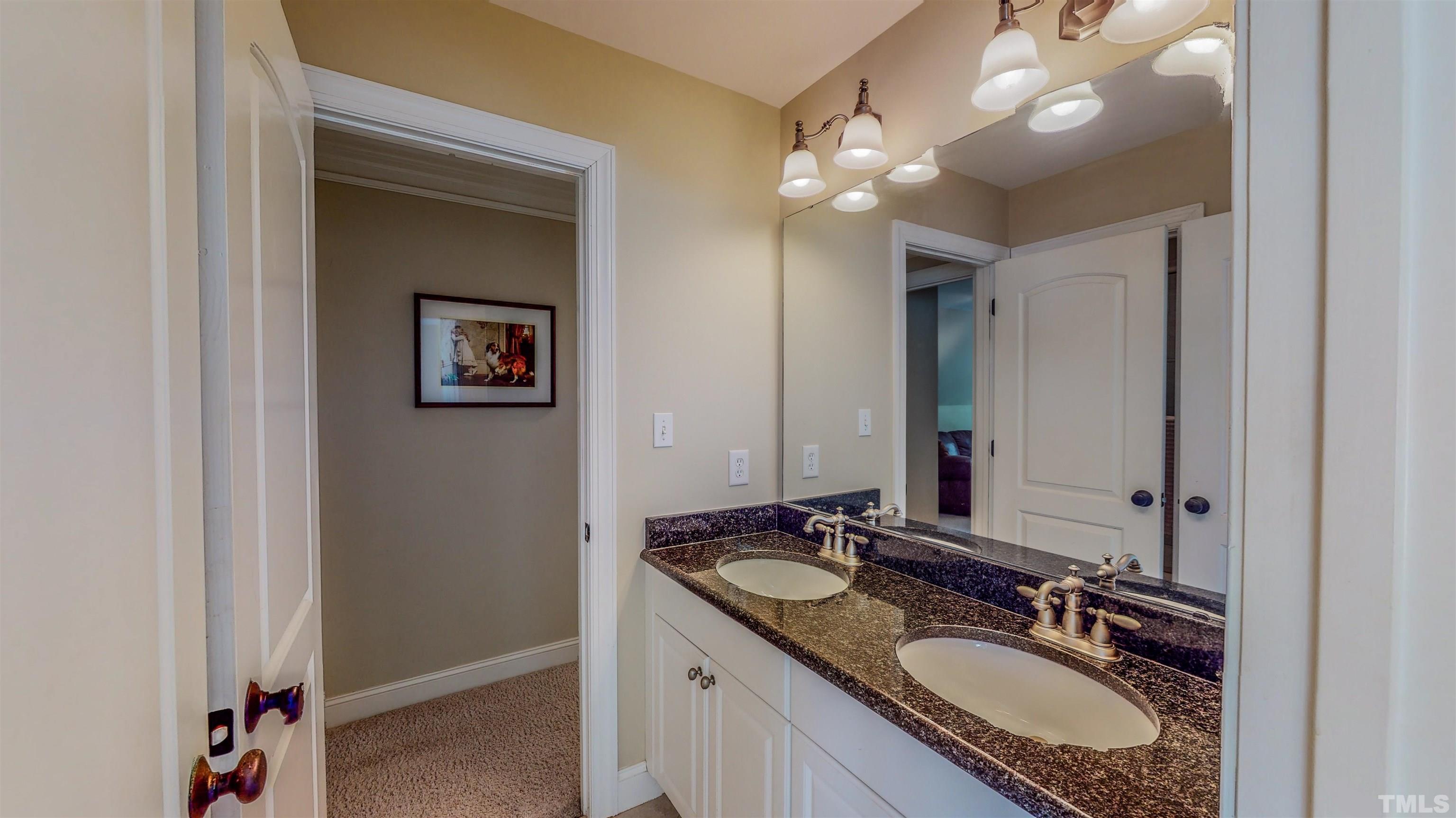 102 Continental Drive Durham, NC 27712 - Photo 45 of 86 a bathroom with a granite countertop double vanity sink a vanity and a mirror