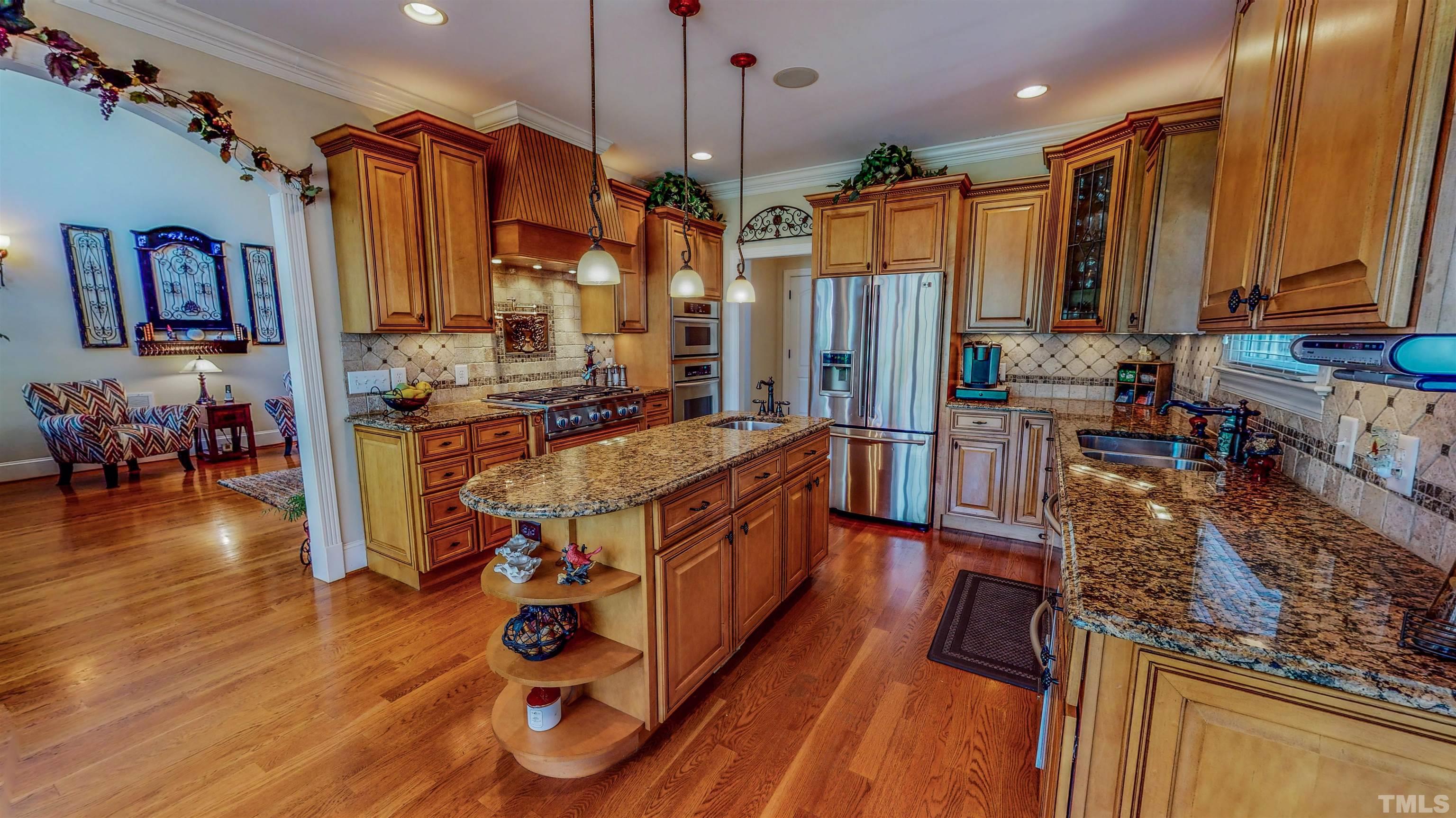 102 Continental Drive Durham, NC 27712 - Photo 54 of 86 a kitchen with stainless steel appliances granite countertop a sink stove and wooden floor