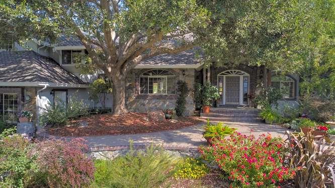 a front view of a house with garden