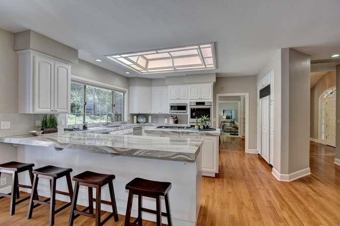 8380 Burchell Road Gilroy, CA 95020 - Photo 14 of 40 a kitchen with stainless steel appliances granite countertop table chairs sink and cabinets