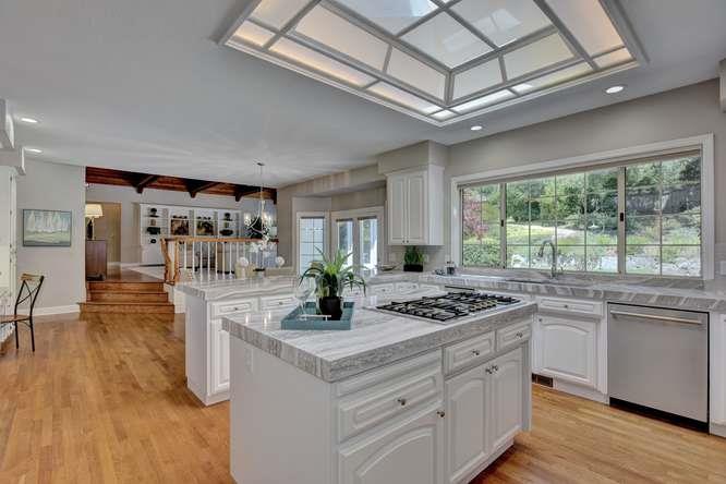8380 Burchell Road Gilroy, CA 95020 - Photo 15 of 40 a kitchen with stainless steel appliances granite countertop a stove a sink dishwasher and cabinets with wooden floor