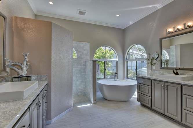 8380 Burchell Road Gilroy, CA 95020 - Photo 20 of 40 a spacious bathroom with double vanity a mirror a double vanity sinks and a bathtub