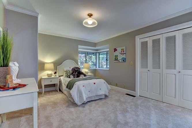 8380 Burchell Road Gilroy, CA 95020 - Photo 22 of 40 a bed room with a bed and a chandelier