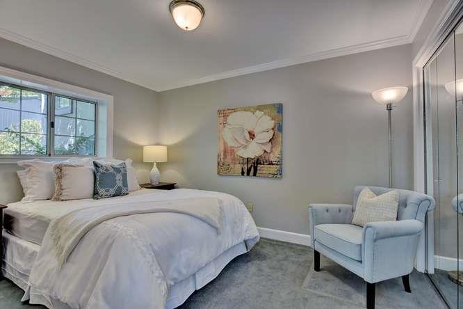 8380 Burchell Road Gilroy, CA 95020 - Photo 25 of 40 a spacious bedroom with a bed and a couch