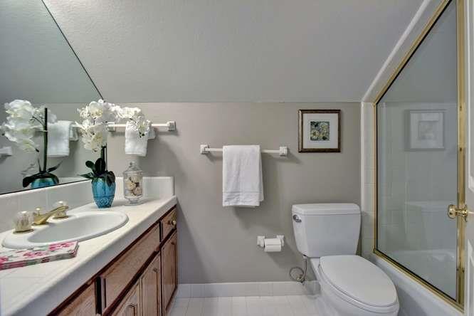 8380 Burchell Road Gilroy, CA 95020 - Photo 30 of 40 a bathroom with a granite countertop toilet sink and mirror