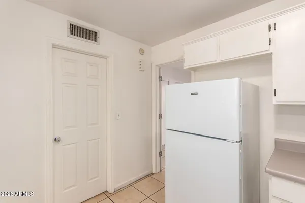 a white refrigerator freezer sitting in a kitchen