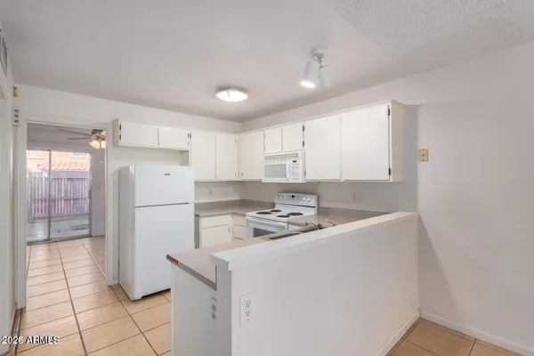 a kitchen that has a sink a refrigerator and a counter top space
