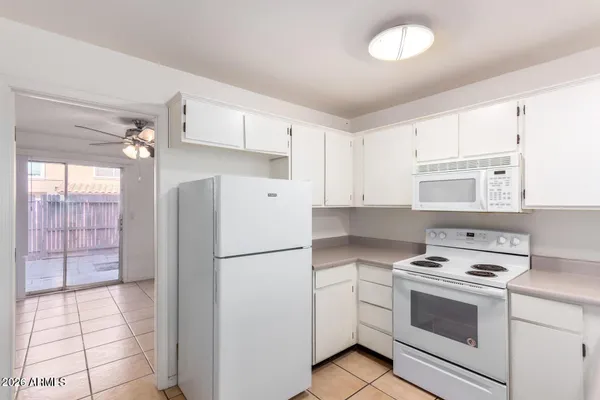 a kitchen with a stove a refrigerator and a sink