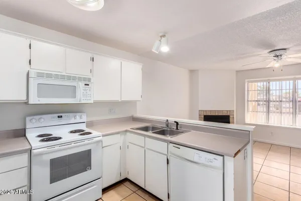 a kitchen with a stove cabinets and a sink
