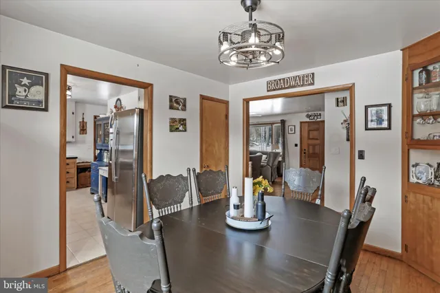 a view of a dining room with furniture wooden floor and chandelier