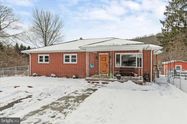 a view of a house with a snow in the yard