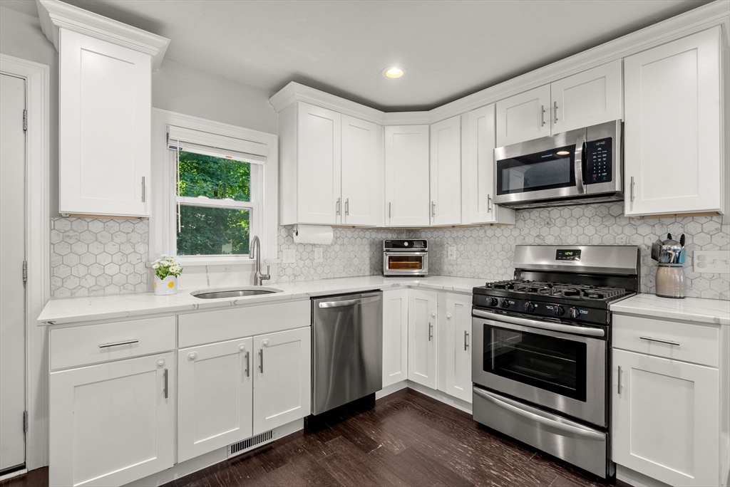 68 Prospect Street Canton, MA 02021 - Photo 8 of 28 a kitchen with cabinets stainless steel appliances a sink and a window