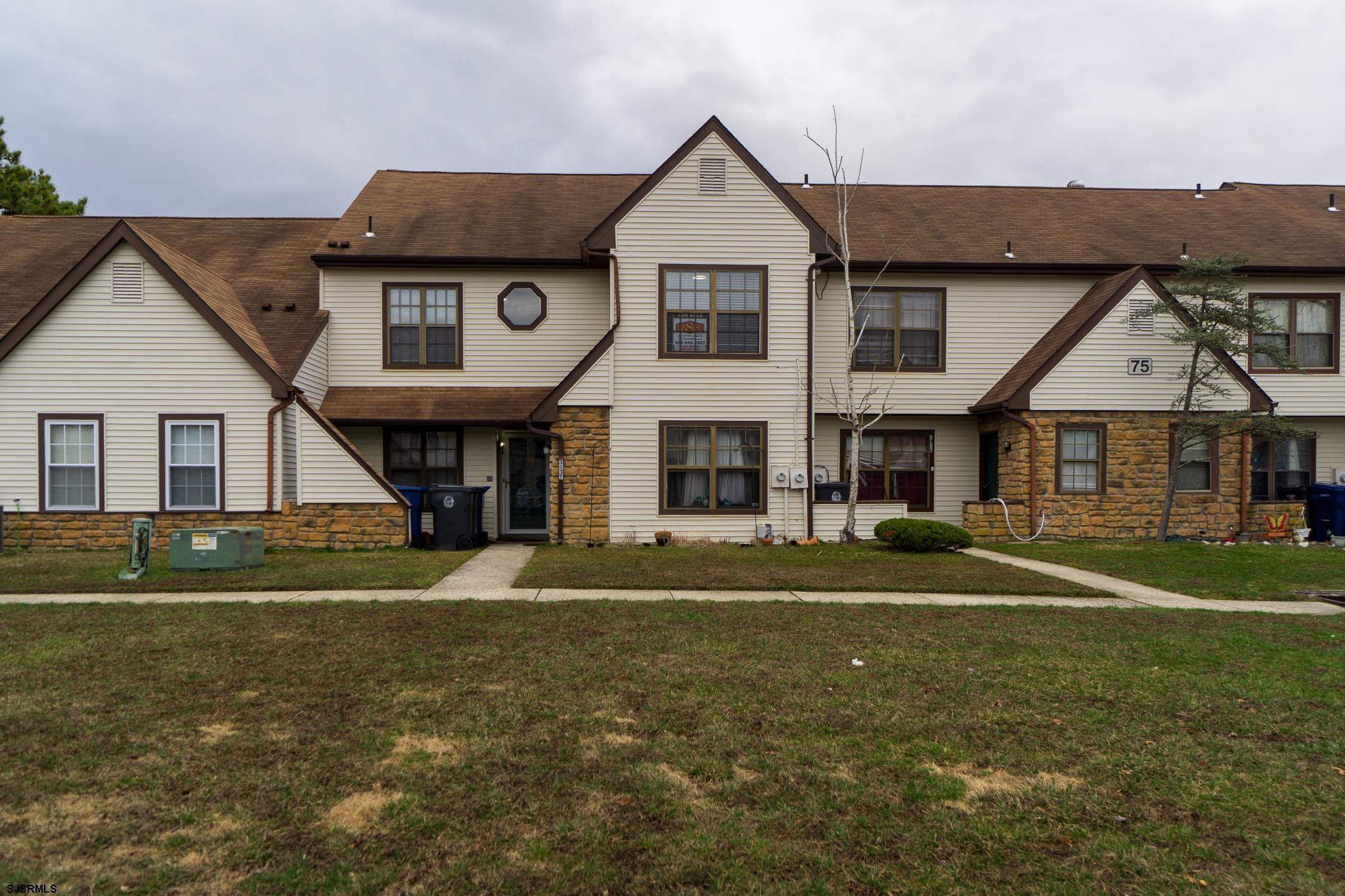 3137 Woodlands Drive, Unit 3137 Mays Landing, NJ 08330 - Photo 1 of 14 a front view of a house with a yard