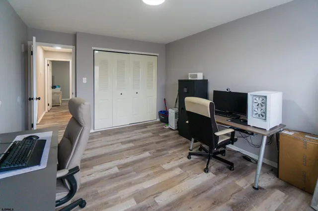 a view of a workspace with furniture and a window