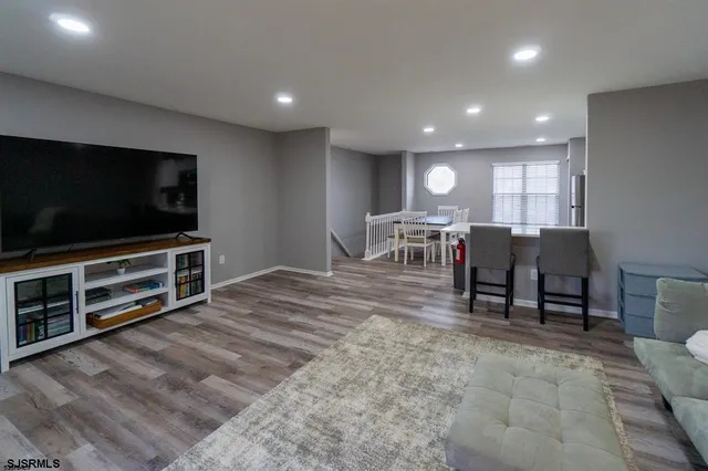 a view of a livingroom with furniture and a flat screen tv