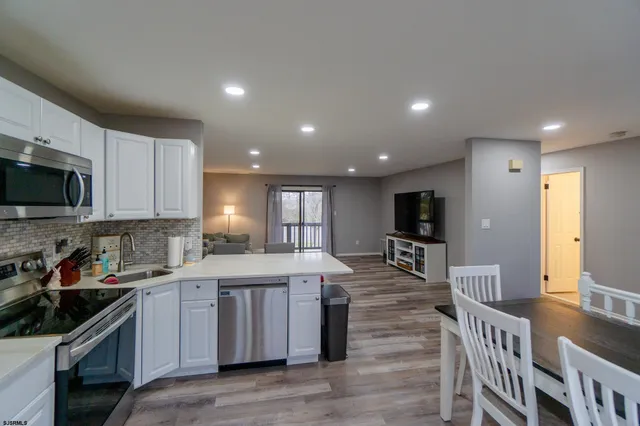a kitchen with counter top space cabinets and appliances