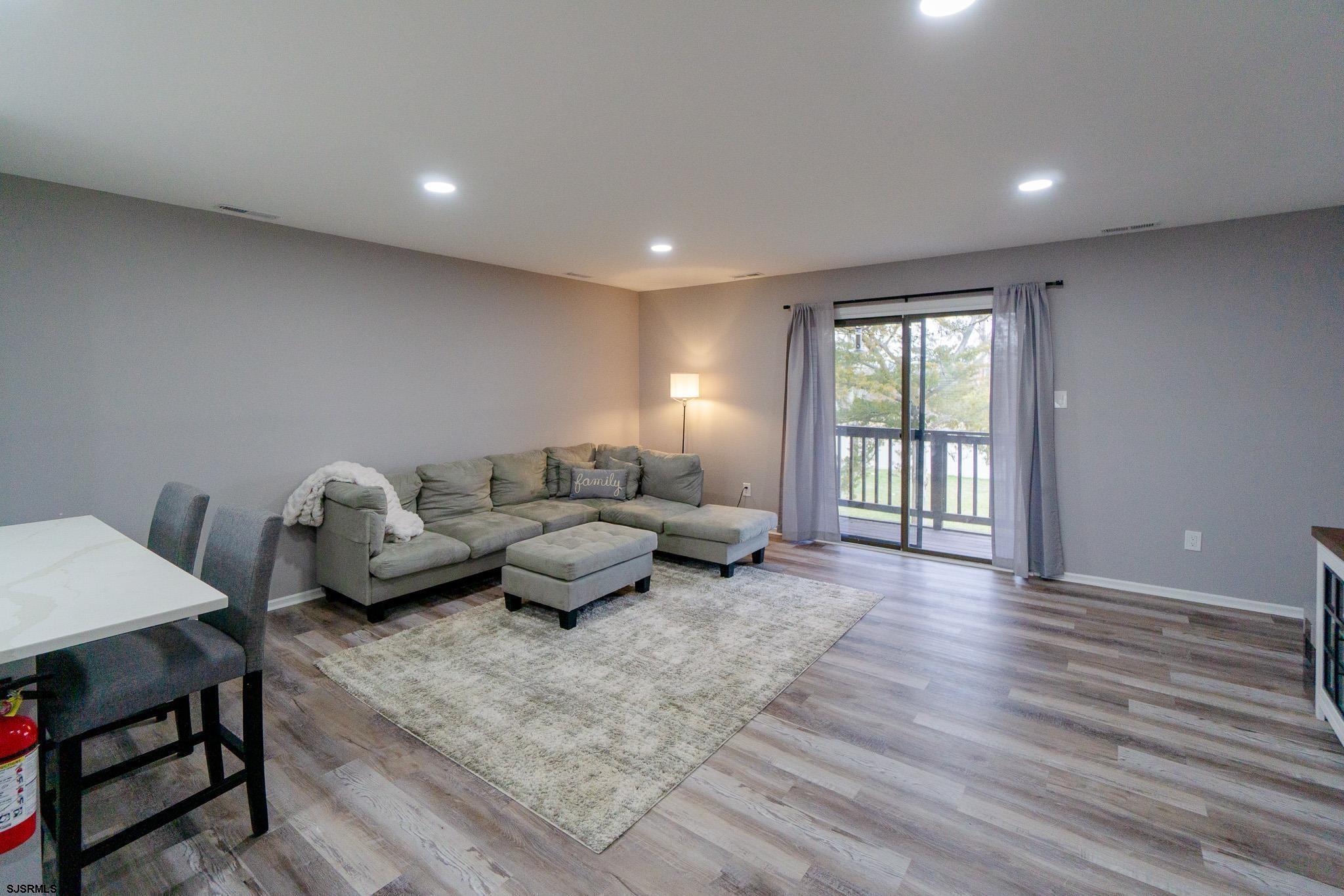 3137 Woodlands Drive, Unit 3137 Mays Landing, NJ 08330 - Photo 5 of 14 a living room with furniture and a wooden floor