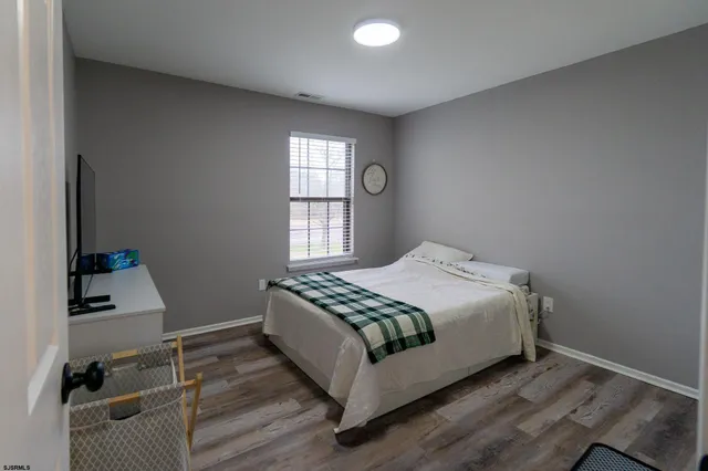 a large bed sitting in a bedroom next to a window