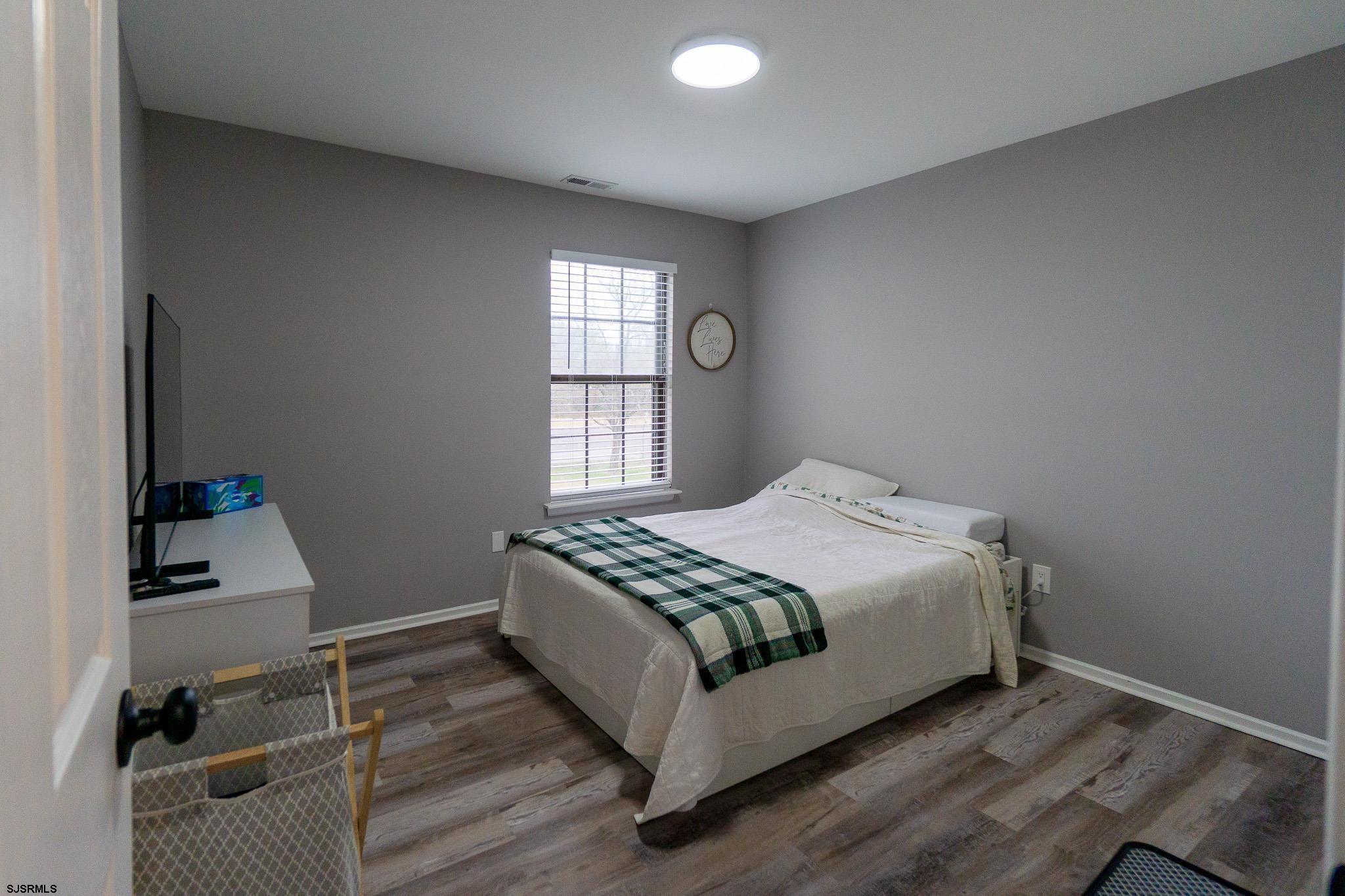 3137 Woodlands Drive, Unit 3137 Mays Landing, NJ 08330 - Photo 8 of 14 a large bed sitting in a bedroom next to a window