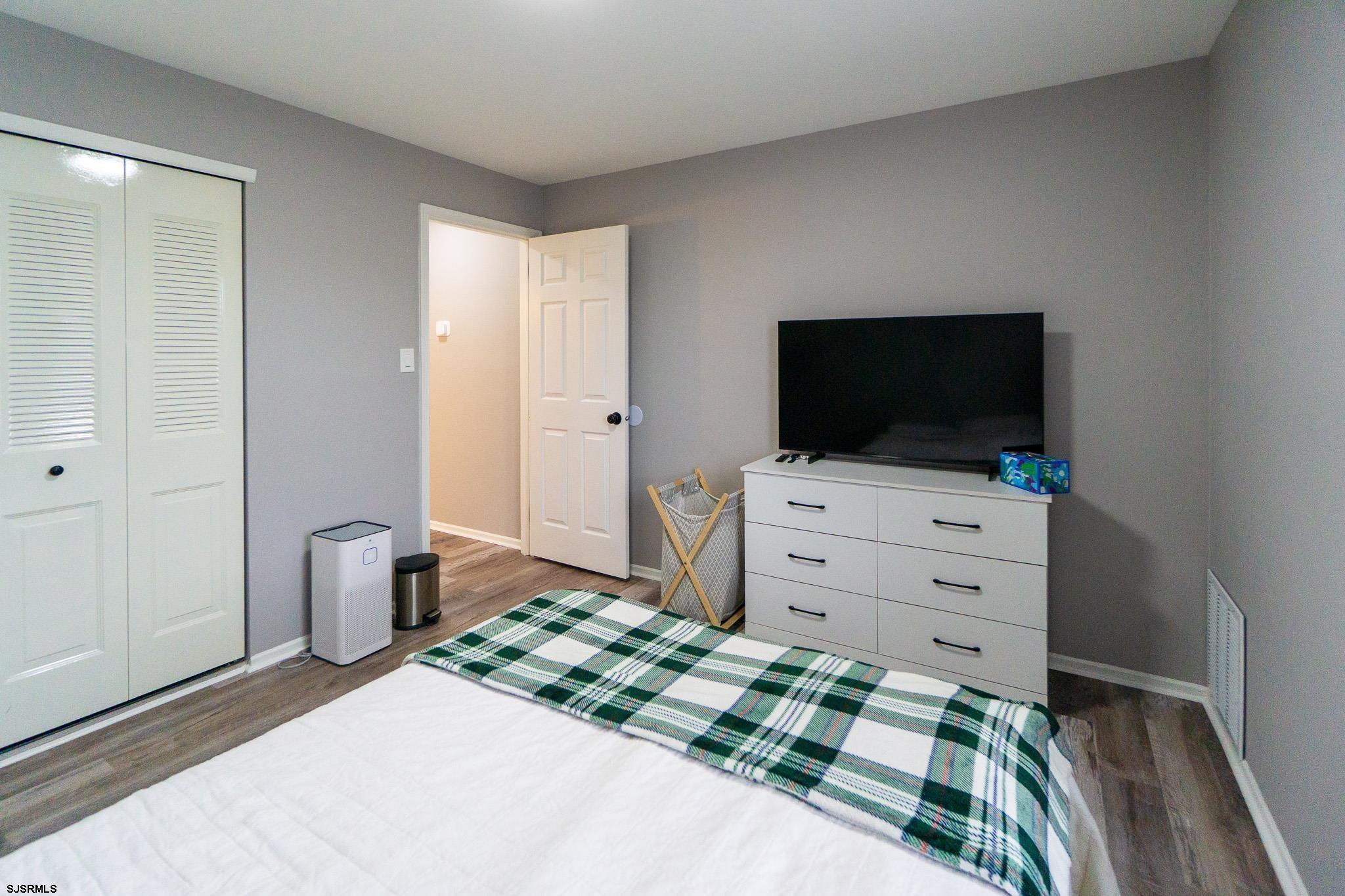 3137 Woodlands Drive, Unit 3137 Mays Landing, NJ 08330 - Photo 9 of 14 a bedroom with a bed and flat screen tv