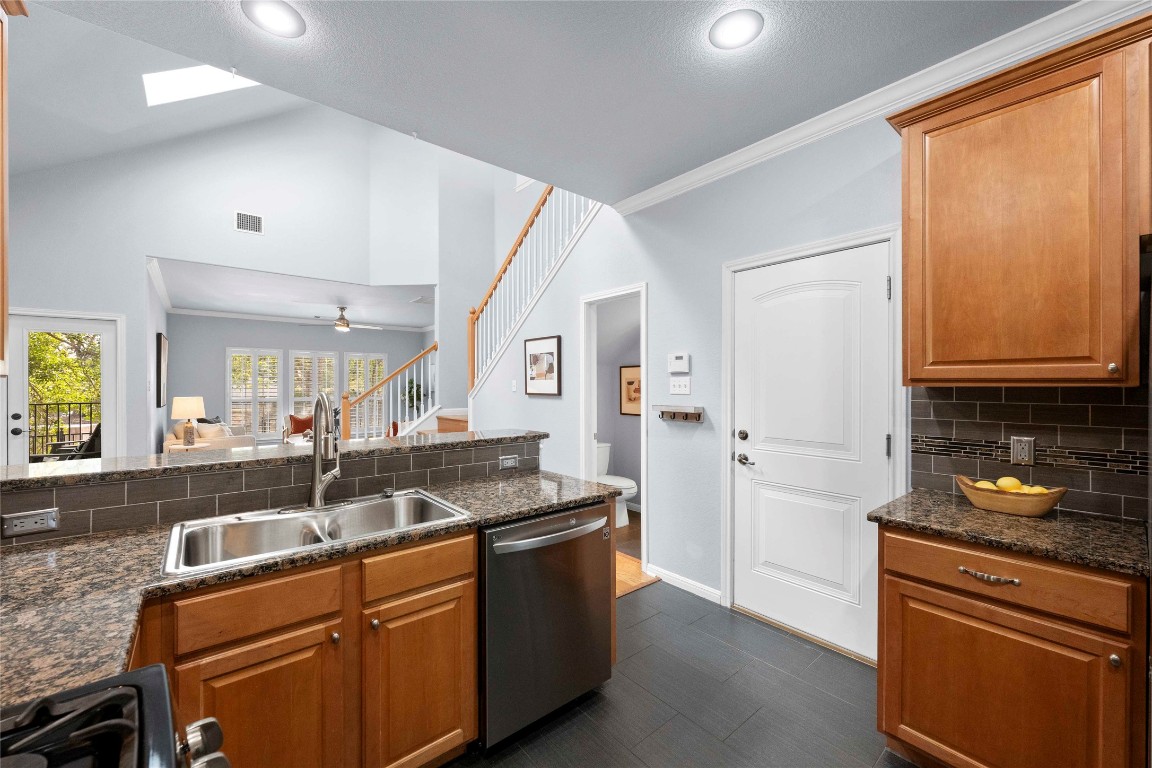 6704 Menchaca Road, Unit 29 Austin, TX 78745 - Photo 12 of 34 a kitchen with granite countertop a sink and a refrigerator