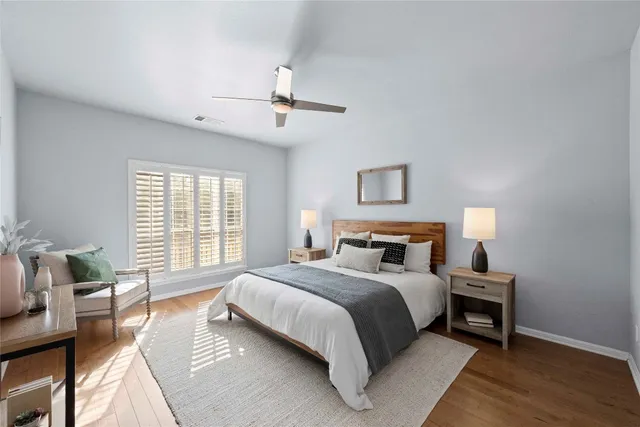 a bedroom with a bed a chandelier and a window