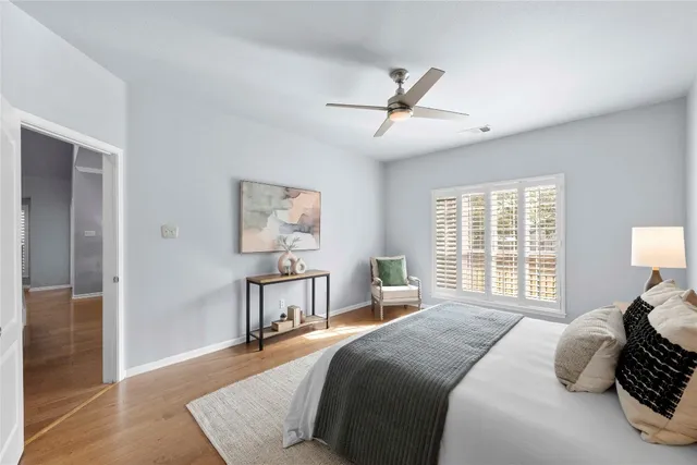 a bedroom with a bed and wooden floor