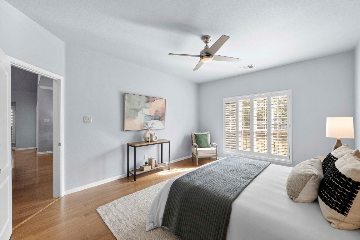 6704 Menchaca Road, Unit 29 Austin, TX 78745 - Photo 16 of 34 a bedroom with a bed and wooden floor
