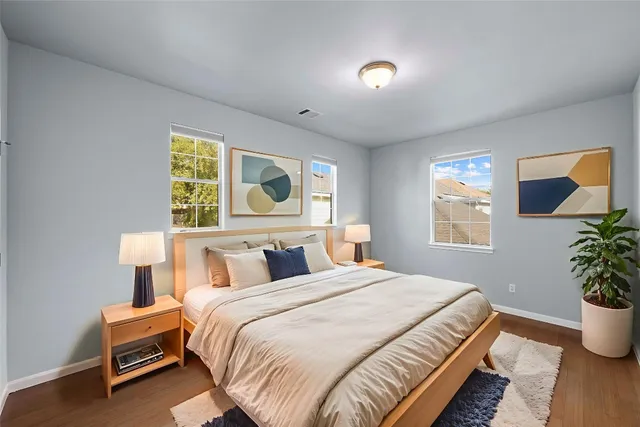 a bedroom with a bed and a potted plant