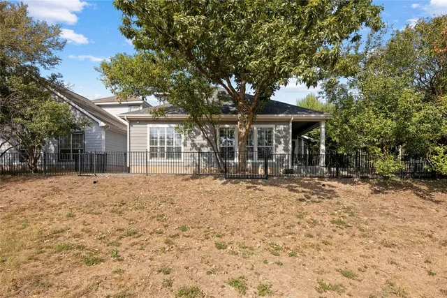 a front view of a house with a tree