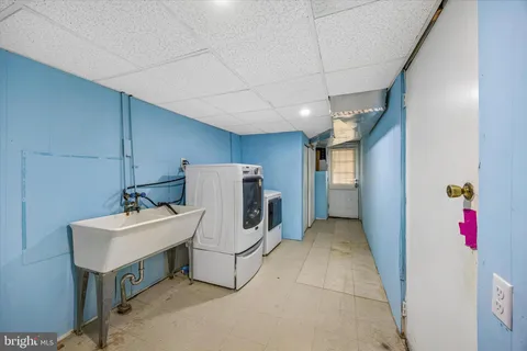 a utility room with closet dryer and washer
