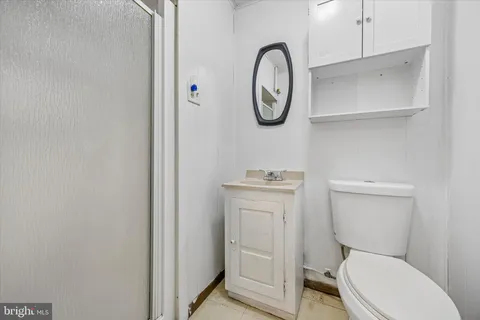 a white toilet sitting next to a bathroom sink