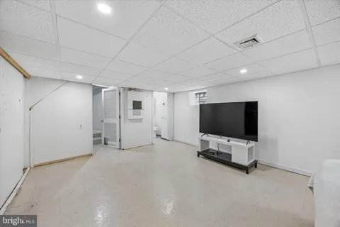 a view of a livingroom with entryway and flat screen tv