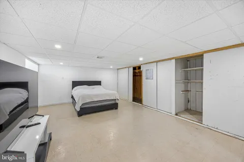a spacious bedroom with a bed and a couch