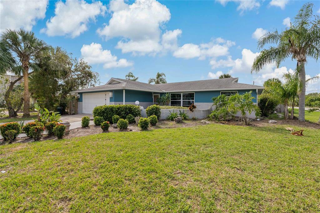 5024 Miller Bayou Drive Port Richey, FL 34668 - Photo 1 of 1 a front view of a house with garden