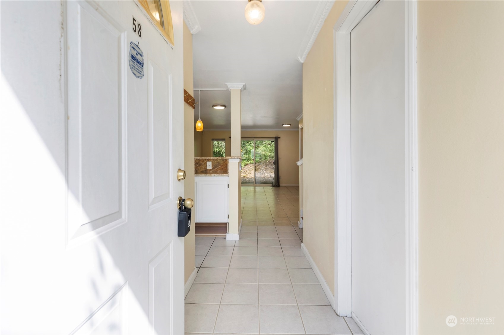 833 Southwest Sunset Boulevard, Unit M58 Renton, WA 98057 - Photo 3 of 24 a view of a bathroom from a hallway