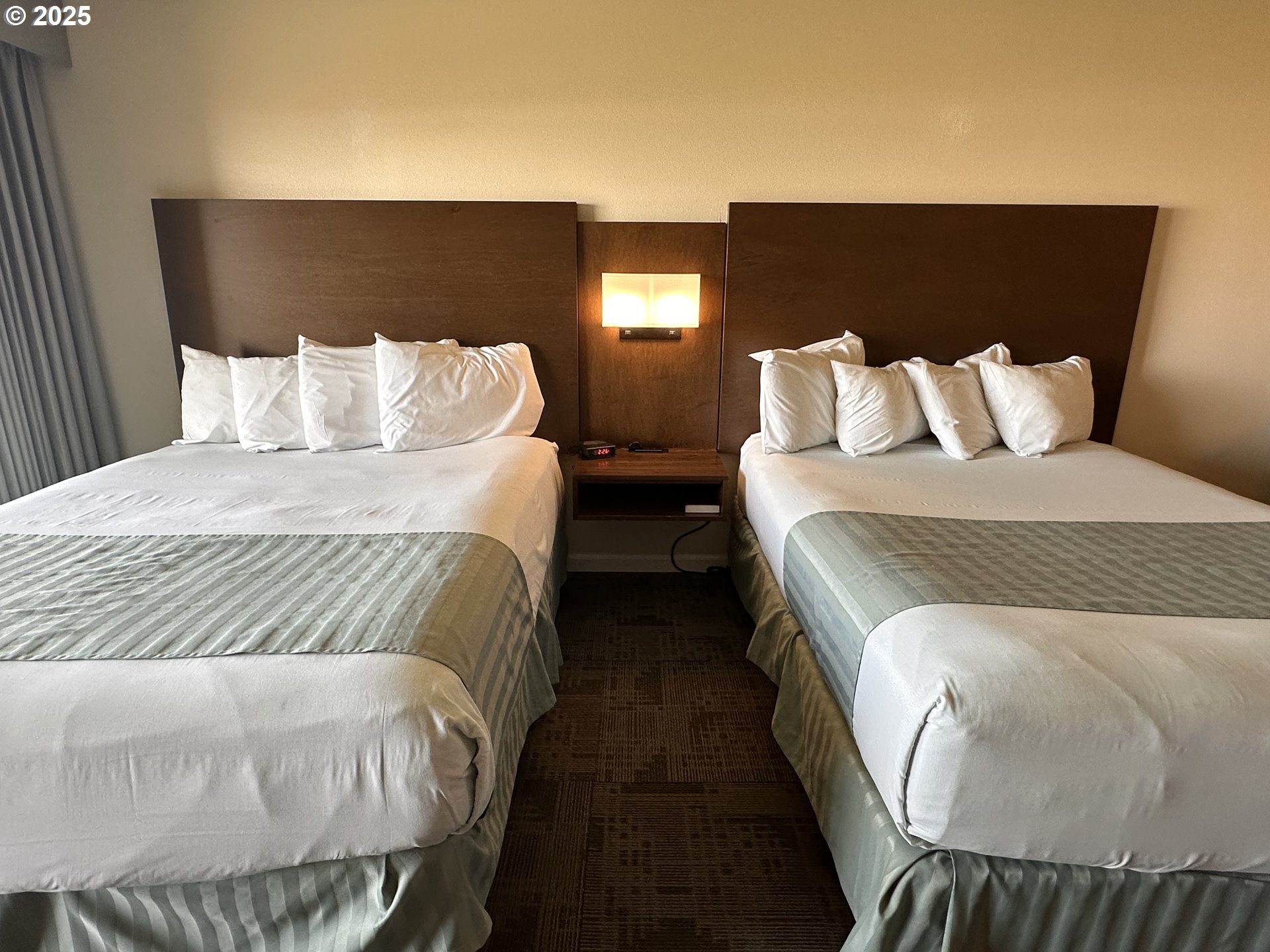 88416 1st Avenue, Unit 303 Florence, OR 97439 - Photo 12 of 21 a large bed sitting in a bedroom next to a lamp