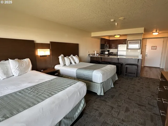 a bedroom with two beds and a mirror