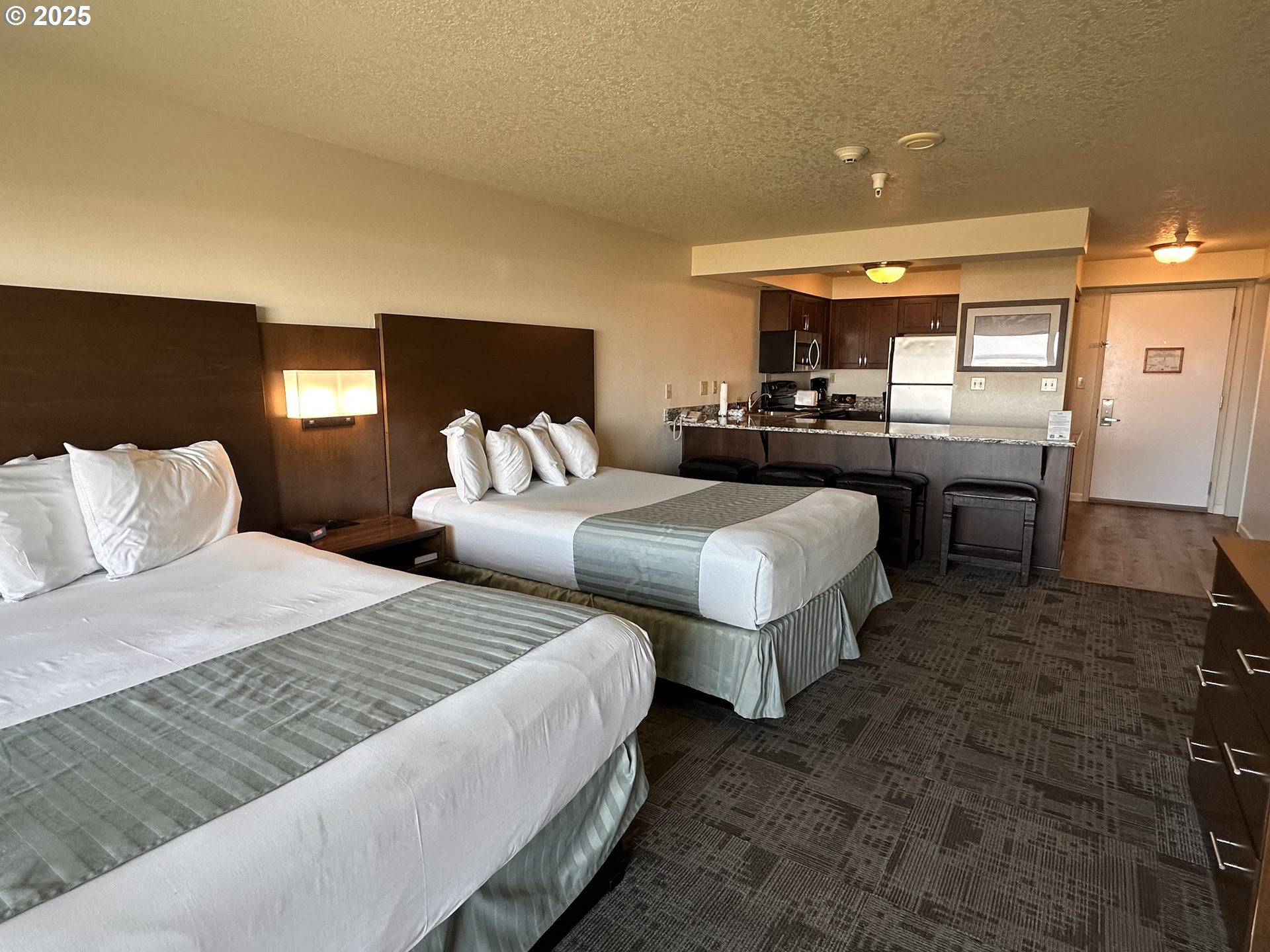 88416 1st Avenue, Unit 303 Florence, OR 97439 - Photo 13 of 21 a bedroom with two beds and a mirror
