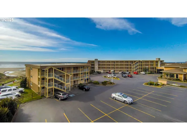 a picture of a building with car parked