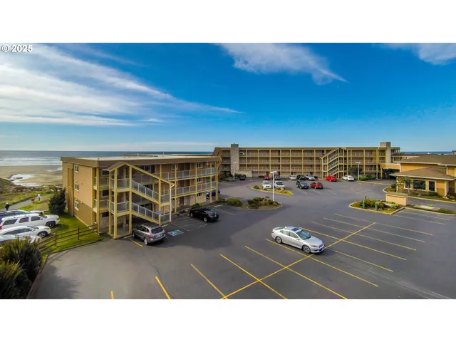 a picture of a building with car parked