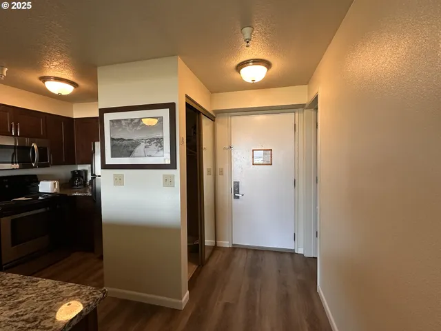 a view of a refrigerator in kitchen and wooden floor