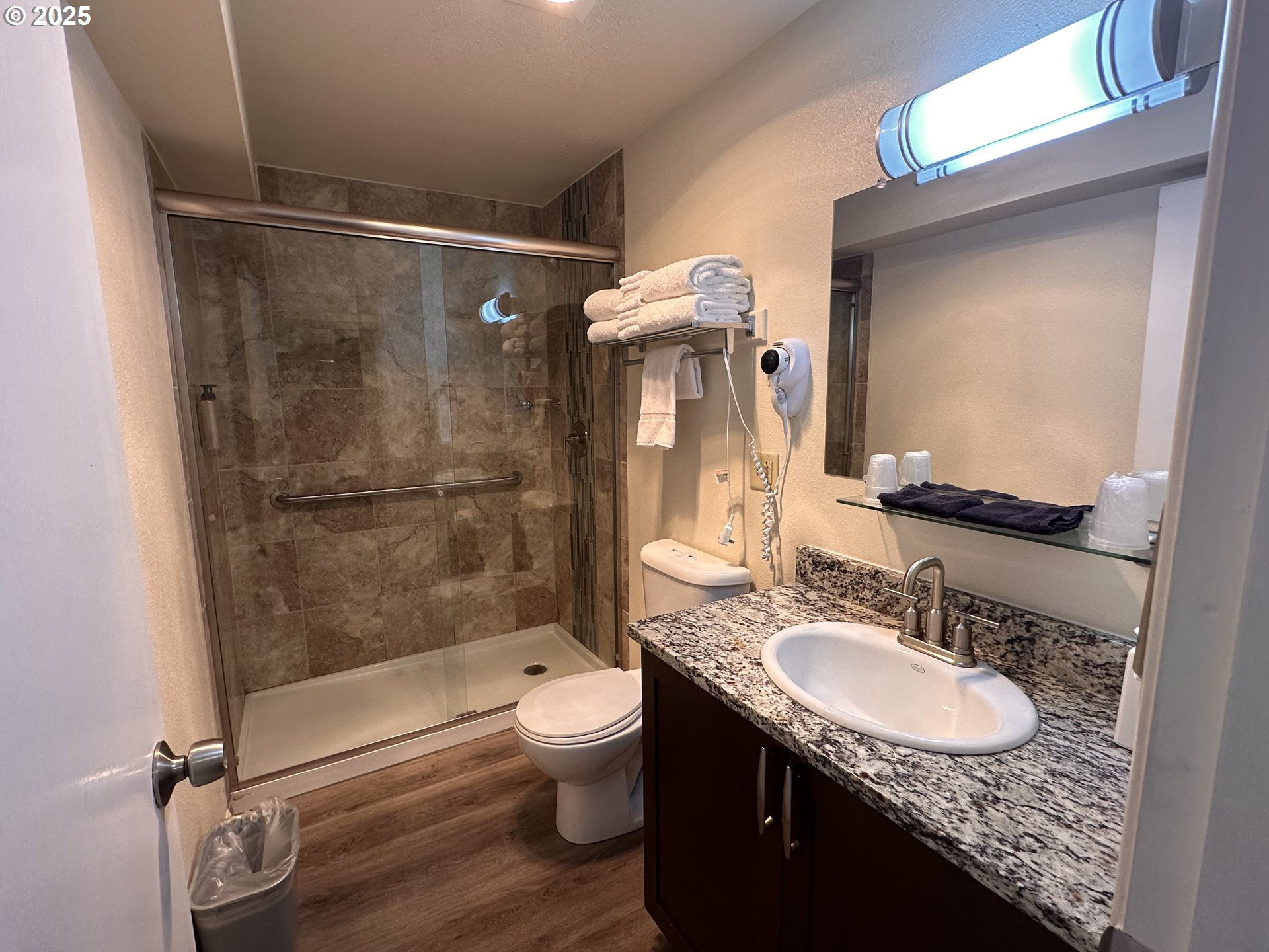 88416 1st Avenue, Unit 303 Florence, OR 97439 - Photo 4 of 21 a bathroom with a granite countertop sink toilet and shower