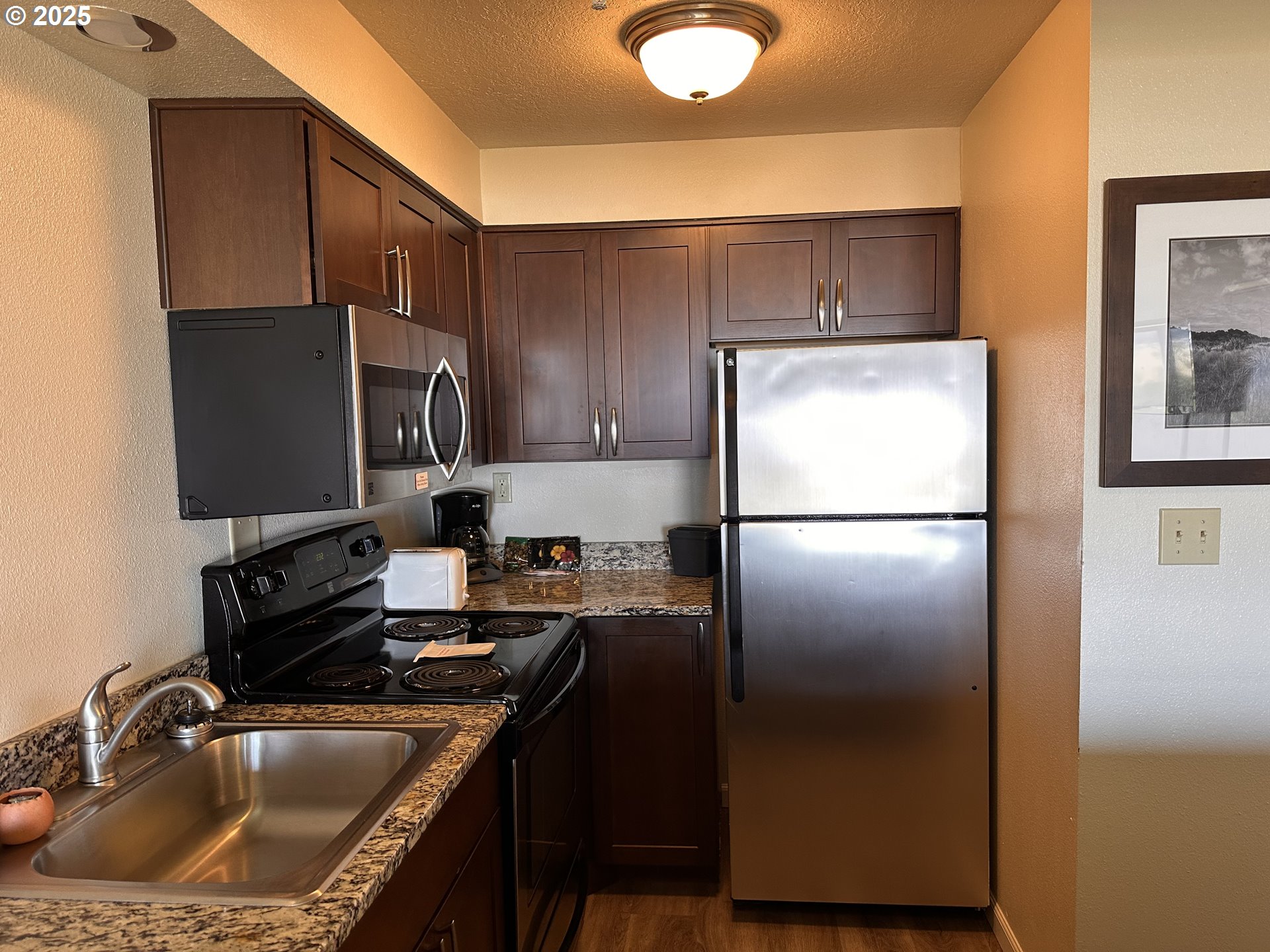 88416 1st Avenue, Unit 303 Florence, OR 97439 - Photo 5 of 21 a kitchen with a refrigerator sink and microwave