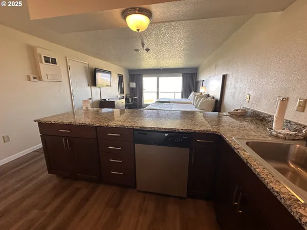 a kitchen with a sink a counter space and a window