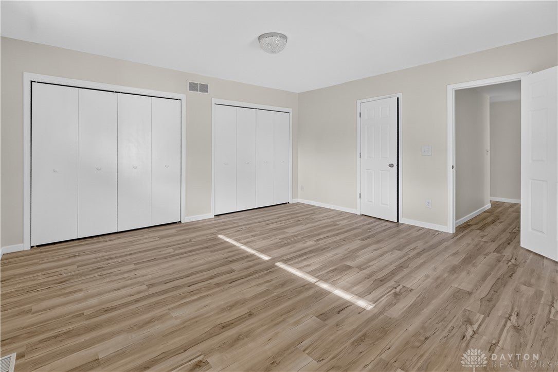1243 Student Avenue Springfield, OH 45503 - Photo 30 of 38 Smooth wood-textured flooring highlights this clean bedroom with ample closet storage.