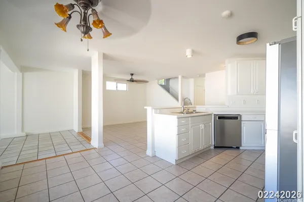 a kitchen with a sink a stove cabinets and utility room