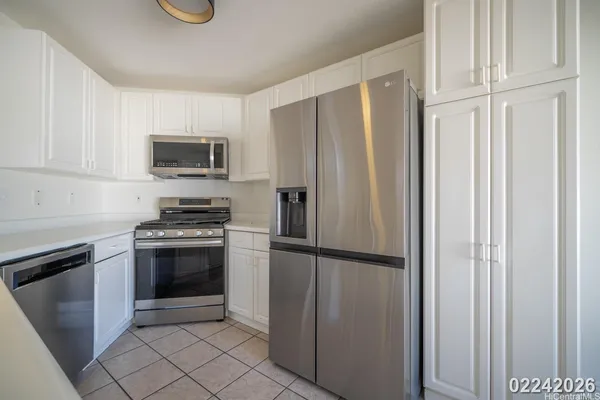 a kitchen with stainless steel appliances granite countertop a refrigerator stove and microwave