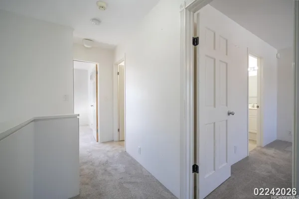 a view of a hallway with closet and door